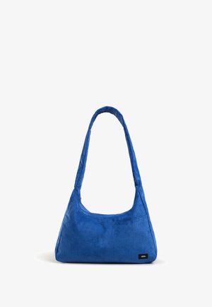 Bolso de hombro azul de pana con una correa larga y una pequeña etiqueta con el logo de Vans en la esquina inferior derecha.