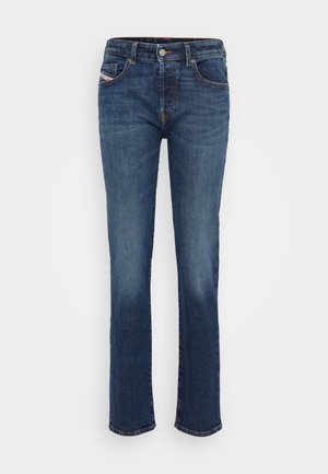 Blue denim jeans with a straight leg cut, featuring five pockets, a button and zipper fly, and subtle stitching accents.