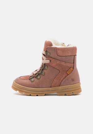 Børns pink vinterstøvle i ruskind med beige gummisål, snørebånd foran, metaløjer, og hvid fleecefor synlig foroven.