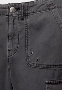 Dark gray denim pants featuring a buttoned waist, stitched seams, side pockets, and two decorative metal rivets near the pocket.
