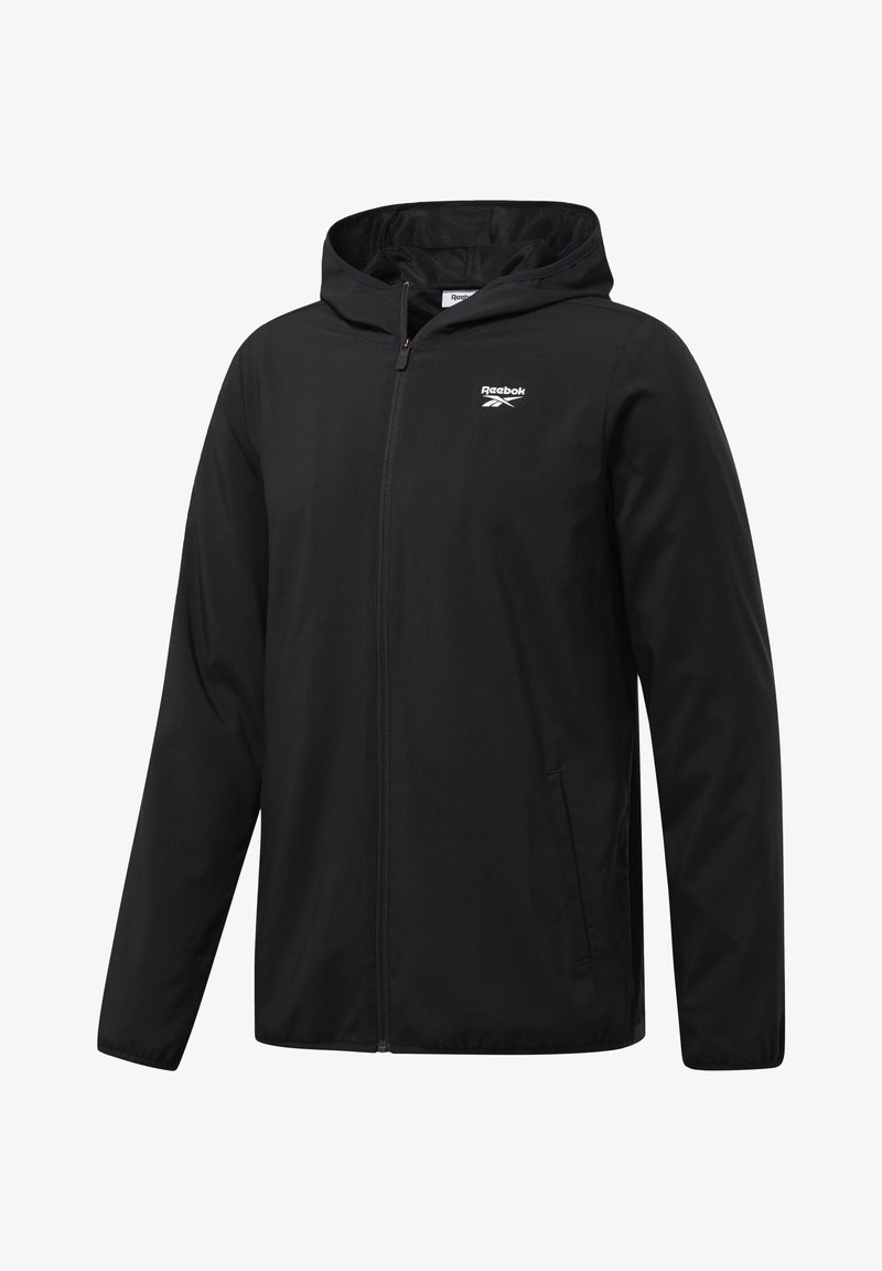 Black zip-up windbreaker jacket with a hood, featuring a lightweight fabric, Reebok logo on the chest, and side pockets.