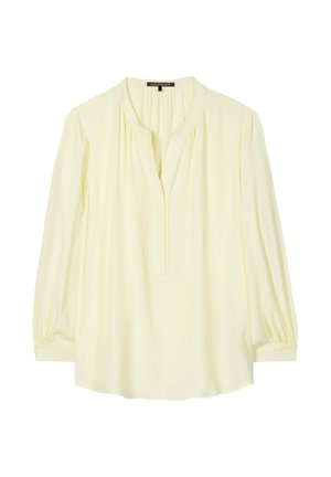 Cremige Langarmbluse mit gerafftem Ausschnitt, V-förmiger Öffnung und elastischen Bündchen, flach auf weißem Hintergrund liegend.