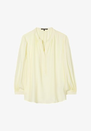 Cream long-sleeve blouse with gathered neckline, V-neck opening, and elastic cuffs, laid flat on white background.