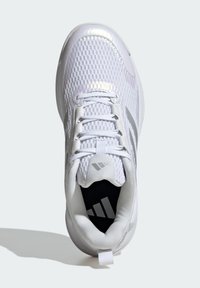 White athletic shoe with a mesh upper, lace-up design, silver accents, and a padded collar. Black insole features a logo. Smooth texture.
