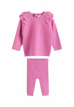 Maglione rosa a coste con spalline arricciate e leggings coordinati a coste. Materiale morbido, scollo tondo e polsini aderenti.