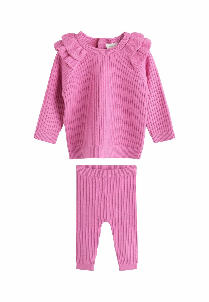 Maglione rosa a coste con spalline arricciate e leggings coordinati a coste. Materiale morbido, scollo tondo e polsini aderenti.