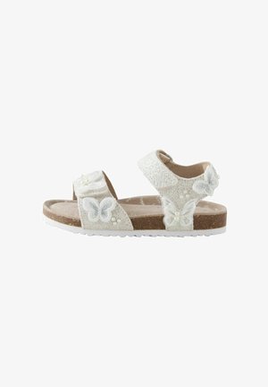 Hvide sandaler med glitrende tekstur, med sommerfugleudsmykninger, justerbare remme og mellemsål af kork. Fleksibel gummiydersål.
