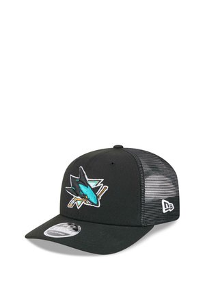 Black mesh snapback cap with teal shark and crossed hockey sticks logo on front, New Era emblem on side, and curved brim.