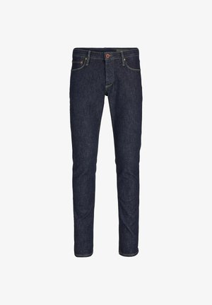 Vaqueros de mezclilla azul oscuro con corte recto, con costuras en contraste y un solo botón rojo en la cintura. Diseño clásico de cinco bolsillos.