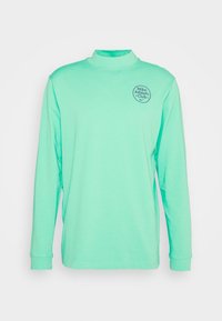 Mint green long-sleeve shirt, features a mock neckline, made of soft fabric, includes a round logo on the left chest area.