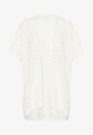 Vit stickad cardigan med ett chevron-mönster, lös passform, korta ärmar och neddragen bakkant. Tyget är lätt och texturerat.