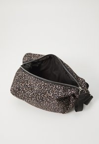 Torba z tkaniny w wzór panterki, zamykana na zamek, o miękkiej fakturze. Czarny materiał wewnętrzny i odpinany pasek z jednej strony.
