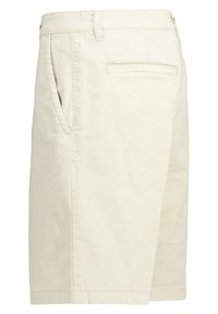 Beige cotton shorts with side pockets and a back pocket. The design features a straight leg cut and stitched detail along the seams.