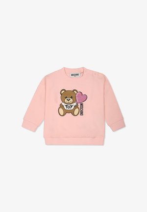 Felpa rosa con maniche lunghe, decorata con una grafica di un orsetto marrone e un cuore glitterato. Include il testo nero "TOY" e polsini a costine.