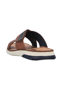 Braune Leder-Sandalen mit einem offenen Design, strukturierten Riemen, einer gepolsterten Innensohle, einer weißen Zwischensohle und einer Gummisohle.