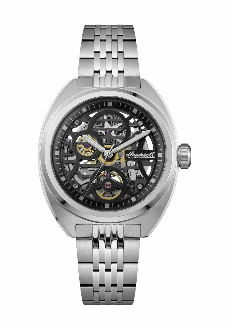 Montre automatique squelette avec bracelet en acier inoxydable argenté ; cadran noir ajouré révélant les rouages et des accents dorés ; boîtier rond avec finition texturée.