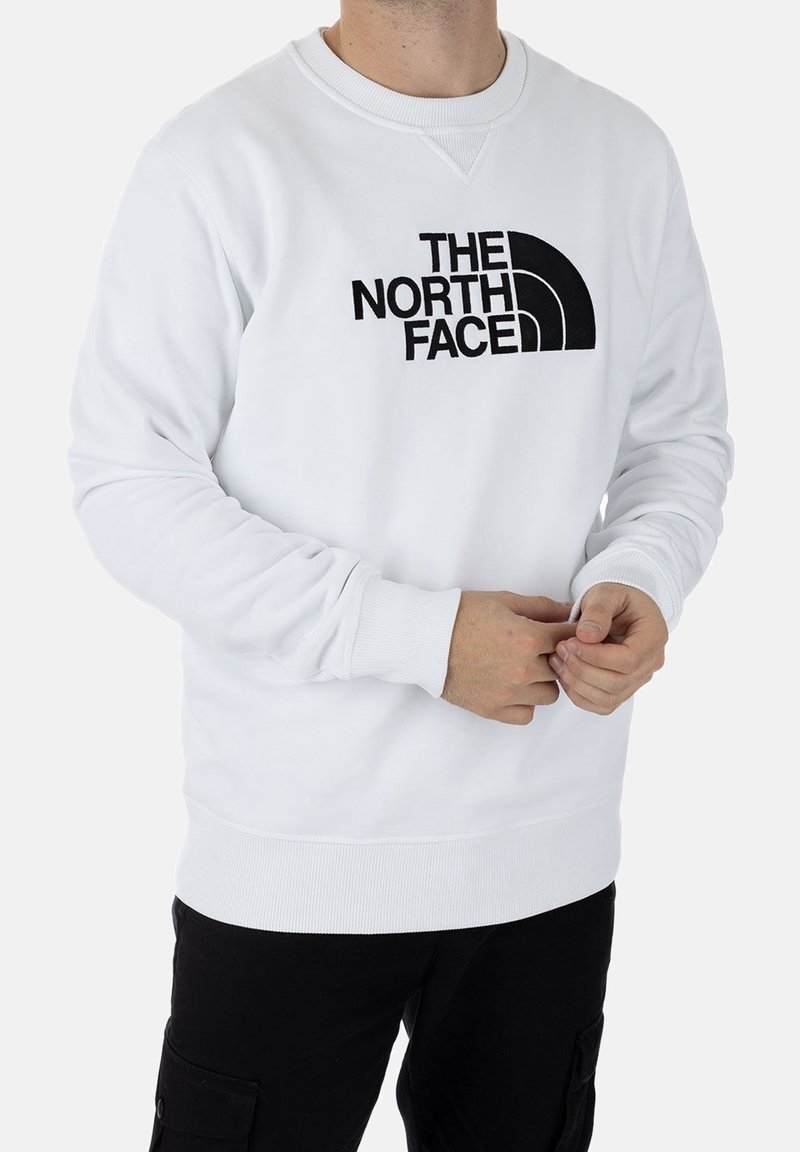 Sudadera blanca de algodón, con un logo bordado en negro "THE NORTH FACE" y puños y cinturilla de canalé.