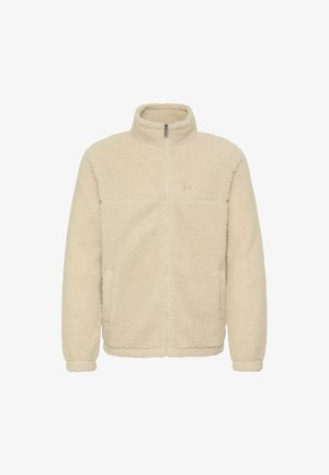 Kremfarget fleecejakke med høy krage, hel glidelås og to sidelommer. Har en teksturert, myk overflate og et enkelt design.