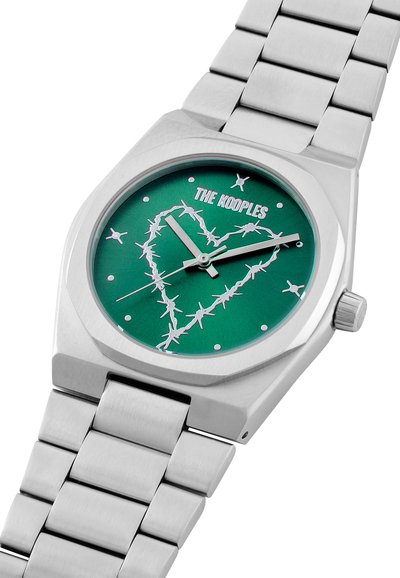 Silver stainless steel watch with octagonal case, green dial featuring barbed wire heart design, silver accents, and a metal link bracelet.