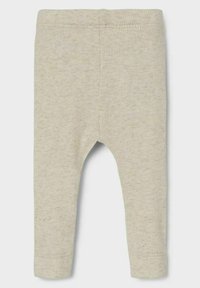 Leggings acanalados en beige claro, con una cinturilla elástica y piernas ajustadas, con una textura suave y un sutil patrón moteado.