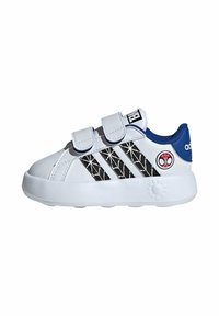 White sneaker with black spider web design, blue accents on the heel, twin Velcro straps, and textured rubber sole. Red Spider-Man logo on the side.