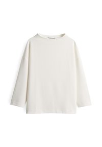 Maglietta a maniche lunghe bianca in maglia testurizzata, con collo rotondo e vestibilità comoda, esposta su uno sfondo bianco uniforme.