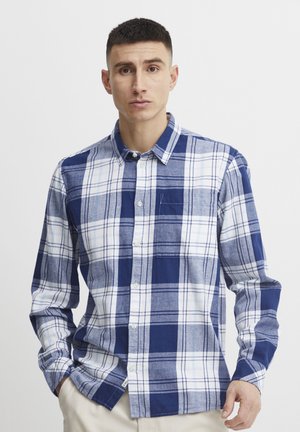 Blue and white plaid shirt in cotton fabric; features a button-down collar, long sleeves, and a chest pocket with a subtle stitch detail.
