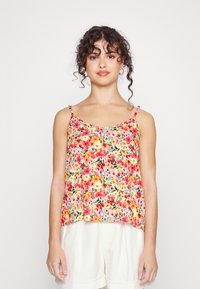 Camisola floral em tecido leve, apresentando flores vermelhas, rosas e amarelas sobre um fundo bege. Possui alças finas ajustáveis e um corte descontraído.