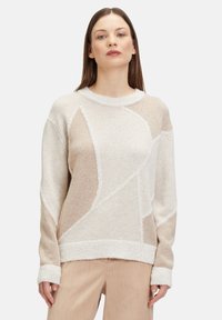 Beige Pullover mit strukturiertem Patchwork-Design in Creme und Taupe. Verfügt über einen runden Halsausschnitt sowie gerippte Bündchen und Saum. Weiches Stofffinish.