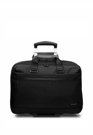 Sac de voyage d'affaires noir à roulettes avec poignée télescopique, poche avant zippée et poignées de transport sur fond blanc.