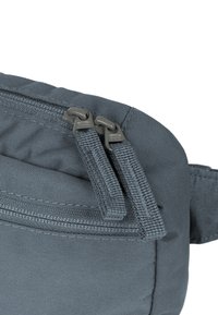 Gray fabric bag with a textured surface, featuring dual zipper pulls and a flat design. There is a thin horizontal zipper pocket.