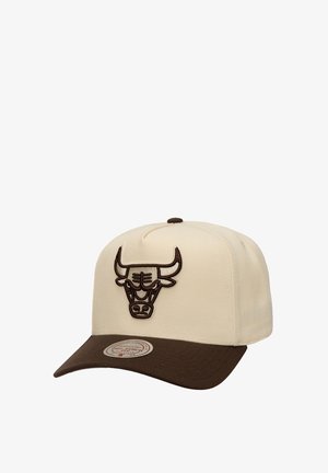 Cream cap with a brown brim, featuring a dark brown embroidered bull logo on the front. Structured design and smooth fabric texture.