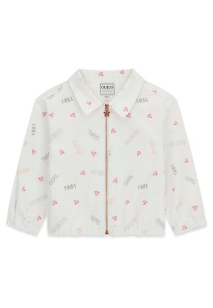 Veste blanche à manches longues avec col, fermeture éclair étoile en or rose, et mots imprimés "LOVE", "GIRL", "GUESS", "1981", ainsi que des icônes de cœur roses.