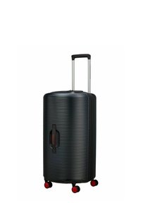Valise rigide noire avec texture nervurée, poignée télescopique argentée et roues rouges. Dispose d'une poignée latérale pour un levage facile.
