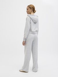 Gray sweat outfit featuring a cropped hoodie with a drawstring and wide-leg pants. Soft fabric with a smooth texture and no visible patterns.