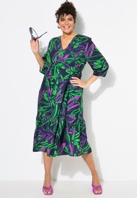 Dunkelblaues Kleid mit Blumenmuster und grünen sowie lila Blättern, mit V-Ausschnitt, Dreiviertelärmlen und gestuftem Saum.