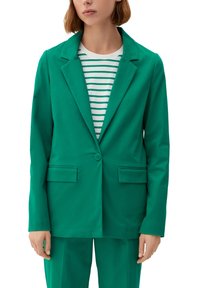 Green blazer made of smooth fabric, featuring a notched lapel, two front pockets, and a single button closure over a striped top.