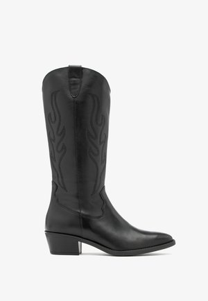 Black leather cowboy boots with flame embroidery detailing, pointed toe, and a stacked heel. Smooth texture and knee-high design.