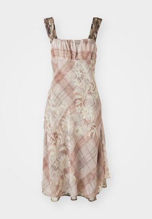 Floral-patterned dress in pink, featuring a ruffled neckline and spaghetti straps. The fabric has a sheer texture with a checked design.