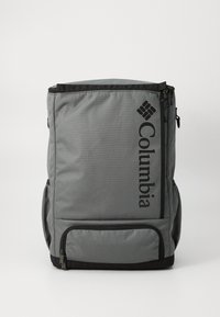 Gray backpack made of durable fabric, featuring a large main compartment, side pockets, and a prominent black logo on the front.