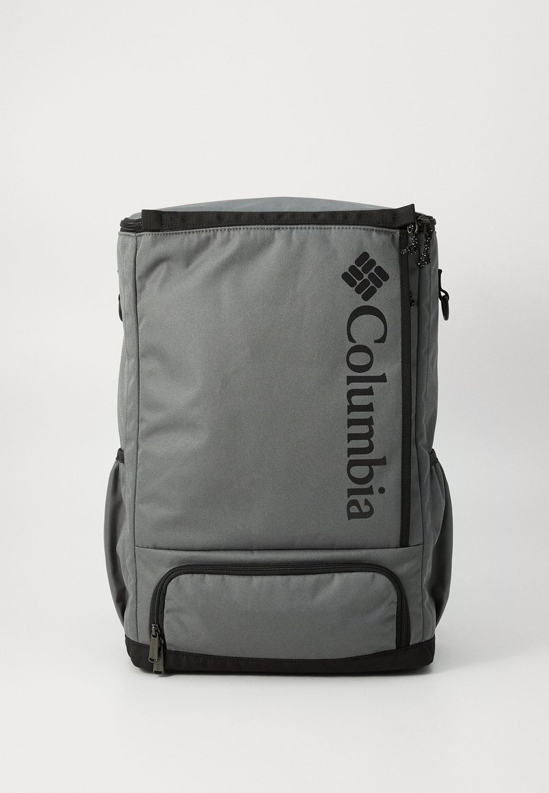 Gray backpack made of durable fabric, featuring a large main compartment, side pockets, and a prominent black logo on the front.