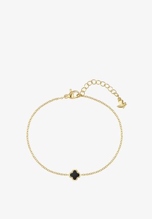 Guld kædearmbånd med et sort firkløvervedhæng og en justerbar lås med et lille vedhæng formet som en fugl.