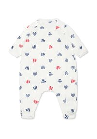 Weißer Jumpsuit mit horizontal gestreiften Herzen in Rot und Blau. Mit langen Ärmeln, gerafften Manschetten und rundem Halsausschnitt. Aus weichem Baumwollmaterial.