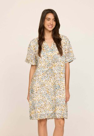 Robe fleurie en tissu léger, avec manches courtes et décolleté en V. Motif comprenant des fleurs jaunes, bleues et vertes sur fond blanc.