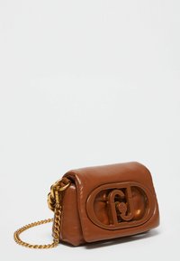 Brown leather crossbody bag with a textured surface, gold chain strap, and a prominent logo accent on the front. Compact rectangular shape.