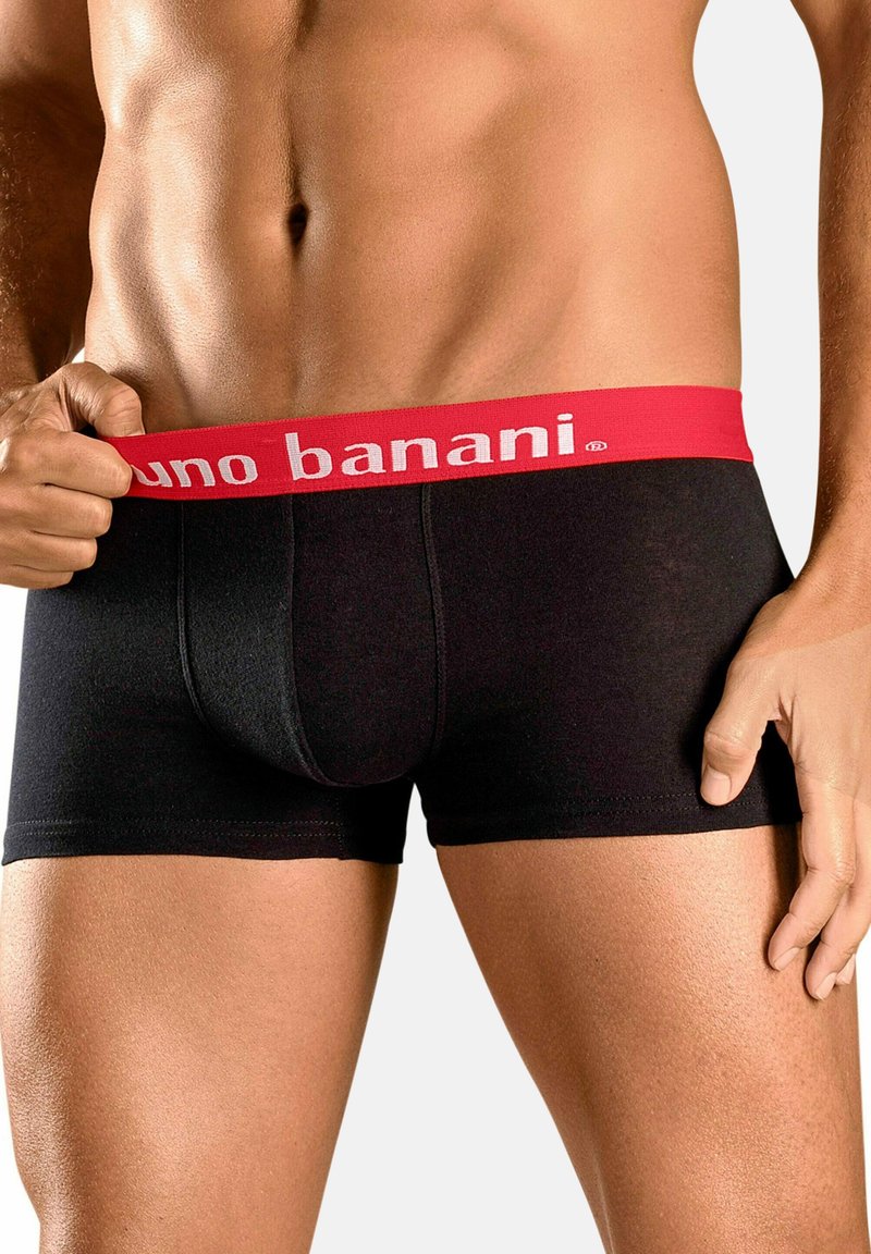 Mustad mustad pokud punase vööga, millel on tekst "uno banani". Sile tekstuur ja istuv disain, rõhutades keha kuju.