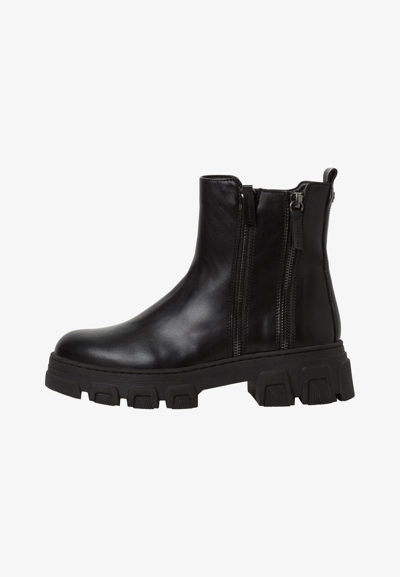 Botte chelsea en cuir noir avec semelle épaisse à crampons et double fermeture éclair latérale, dotée d'une languette à l'arrière pour faciliter l'enfilage.