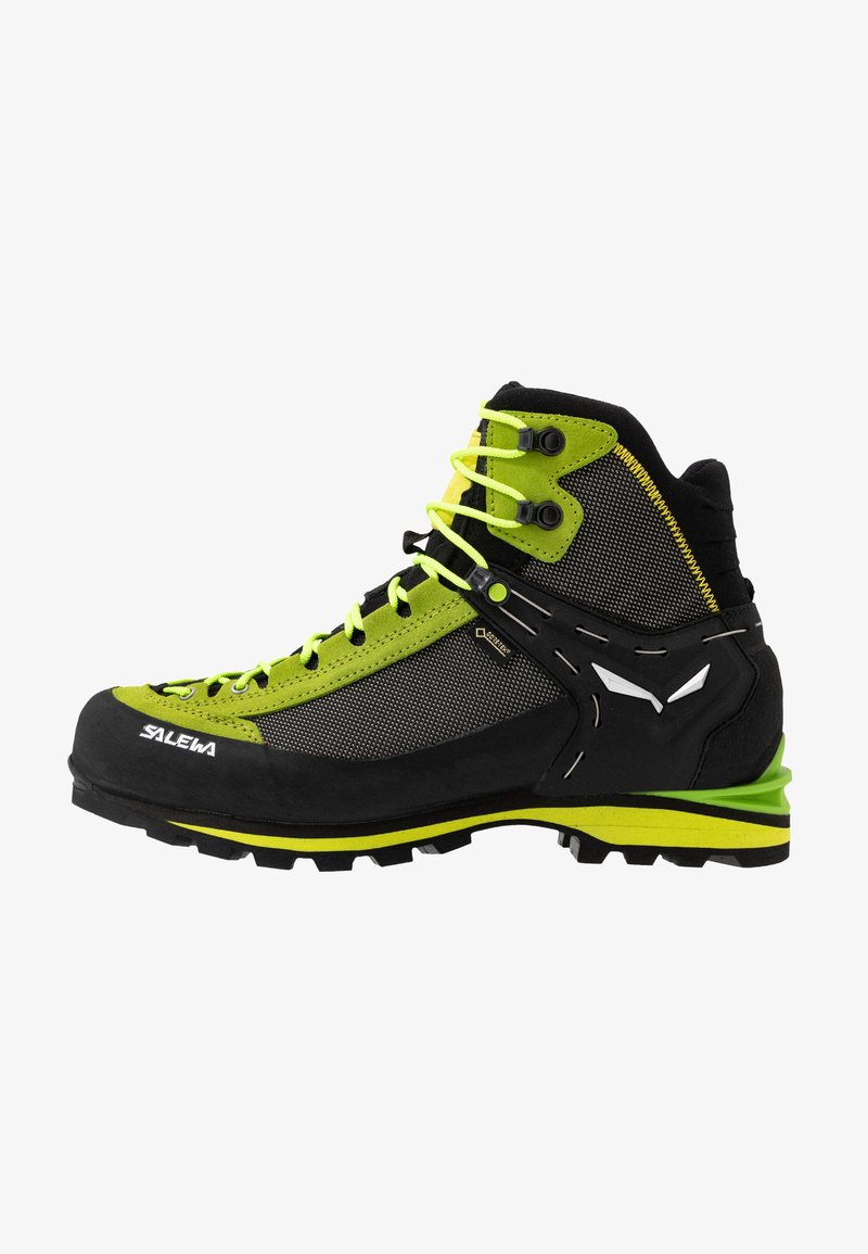 Bota de caminhada de cano alto em preto e verde limão vibrante. Possui parte superior em malha, sola em borracha e detalhes contrastantes com um sistema de cordões robusto.
