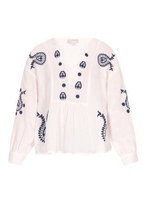 Valge pluus pikkade varrukatega, millel on tumesinised lille- ja paisleemustrid. V-kujuline kaelus ja kogutud vöökoht.