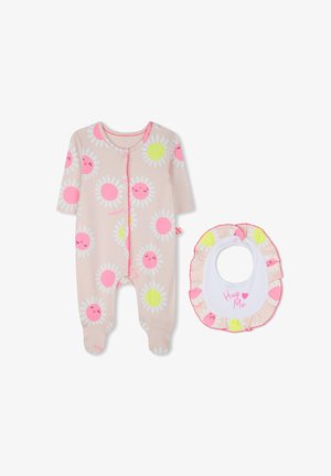 Peach-colored baby onesie with floral pattern, pink accents, and snap closure; matching white bib with ruffled edges and "Hug Me" text.